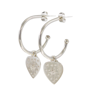 A pair of silver hoop earrings with heart charms and small star-shaped embellishments.