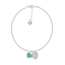 Sterling silver anklet with resin aqua heart, heart charm, and adjustable fit.