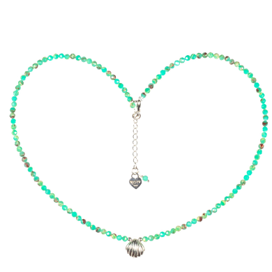 Necklace with shell pendant forming a heart shape on a white background