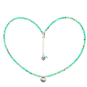 Necklace with shell pendant forming a heart shape on a white background