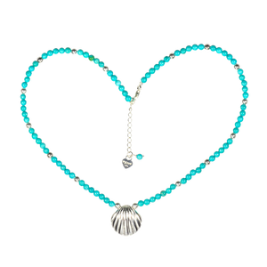 Turquoise beaded necklace with a silver shell pendant on a white background
