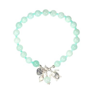 Turquoise beaded bracelet with silver charms on a white background