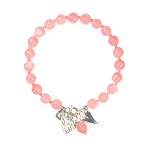 Pink beaded bracelet with silver charms on a white background