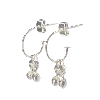 Silver hoop earrings with dangling cherry charms on a white background