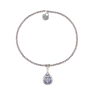 A sterling silver bracelet featuring a small padel racket charm and 2mm beads strung on elastic, with a signature logo at the clasp.