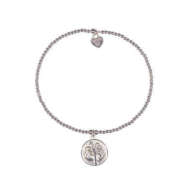 A 925 sterling silver bracelet featuring a small coin featuring a tropical tree and a signature logo.