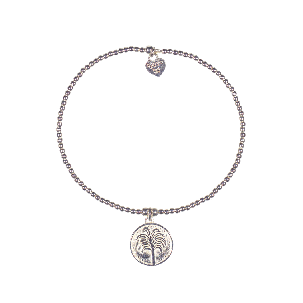 A 925 sterling silver bracelet featuring a small coin featuring a tropical tree and a signature logo.
