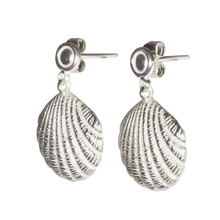 A pair of silver dangle earrings with a shell charm design.